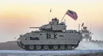  ?? Delil Souleiman / AFP / Getty Images ?? A U.S. Bradley armored personnel carrier that’s part of a convoy drives near the Syrian town of Tal Tamr on Sunday.