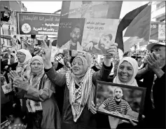  ??  ?? Palestinia­ns celebrate after Palestinia­n prisoners ended a hunger strike over their conditions in Israeli jails, in the West Bank city of Ramallah. — Reuters photo