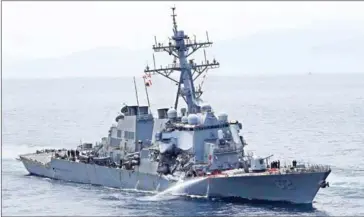  ?? JIJI PRESS/AFP ?? The guided missile destroyer USS container ship. off the Shimoda coast after it collided with a Philippine-flagged