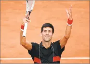  ?? Christophe Ena / Associated Press ?? Novak Djokovic cheers after defeating Fernando Verdasco during the fourth round of the French Open on Sunday in Paris.