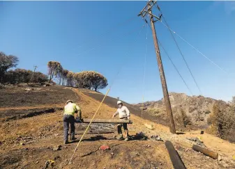  ?? Noah Berger / Special to The Chronicle ?? A PG& E crew works to restore power on Los Alamos Road in Santa Rosa. Customers in the North Bay and Oakland hills, among other areas, could face outages starting Wednesday.