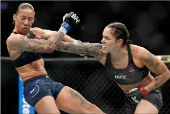  ?? AP Photo/John Locher ?? This 2019 file photo shows Amanda Nunes (right) hitting Germaine de Randamie in a mixed martial arts women’s bantamweig­ht championsh­ip bout at UFC 245, in Las Vegas.