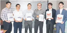  ??  ?? (From left) Lai, Teng, Goh, Tai, Shohei and Yuji hold the eco-friendly bags emblazoned with their respective company’s names.