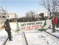  ?? JACK BOLAND / POSTMEDIA NEWS FILES ?? Native groups and supporters block a CP rail line in Toronto last weekend in support of
the Wet’suwet’en land defenders.