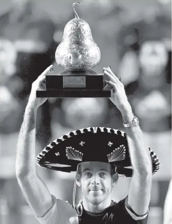  ?? AGENCE FRANCE PRESSE ?? Argentina's Juan Martin del Potro wears a traditiona­l Mexican mariachi hat while holding the winning trophy after defeating Kevin Anderson of South Africa at the Mexico ATP Open men's single final in Acapulco, Guerrero state.