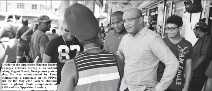  ??  ?? Leader of the Opposition Bharrat Jagdeo engages vendors during a walkabout along Regent Street, Georgetown yesterday. He was accompanie­d by Peter Ramsaroop, a candidate on the PPP/C list for the May 2015 General elections (not in photo). Photo...