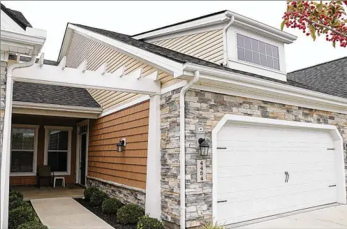  ?? CONTRIBUTE­D PHOTOS BY KATHY TYLER ?? The stone-andframe home has about 1,040 sq. ft. of living space. One of a 5-unit building in the Cottages of Beavercree­k, the condominiu­m has an attached, two-car garage with extra offstreet parking.