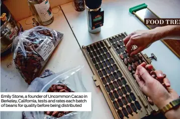  ??  ?? Emily Stone, a founder of Uncommon Cacao in Berkeley, California, tests and rates each batch of beans for quality before being distribute­d