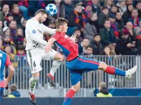  ?? — AFP ?? Real Madrid’s Spanish defender Nacho Fernandez and CSKA Moscow’s Slovenian midfielder Jaka Bijol vie for the ball during the Uefa Champions League Group G match at the Luzhniki stadium in Moscow.