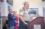  ??  ?? Taos County Sheriff Jerry Hogrefe, with Taos District Attorney Donald Gallegos and CYFD Secretary Monique Jacobson looking on, speaks at a Tuesday news conference.