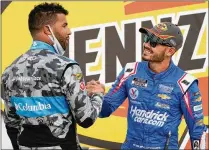  ?? JOHN LOCHER/AP ?? Bubba Wallace (left), NASCAR’S only Black full-time driver, was among those to congratula­te Kyle Larson on his first win after coming back from a suspension for using a racial slur.