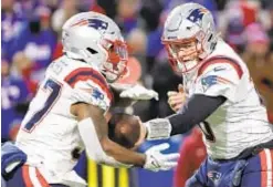  ?? GETTY ?? Patriots QB Mac Jones spends most of game handing ball off against Bills on Monday, and New England wins its seventh straight.