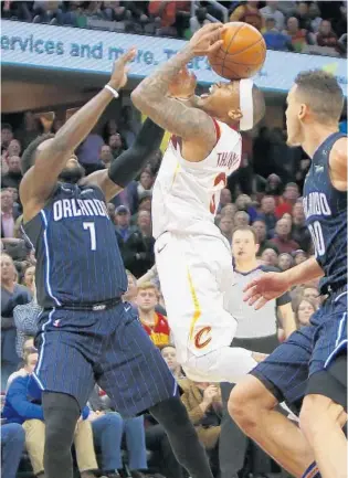  ?? JUSTIN K. ALLER/GETTY IMAGES ?? Cleveland’s Isaiah Thomas torched Orlando for 21 points on Wednesday night, including 2 key free throws after this questionab­le foul call against Magic guard Shelvin Mack in the game’s closing seconds.