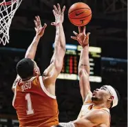  ?? Wade Payne/Associated Press ?? Tennessee forward Olivier Nkamhoua shoots over Texas forward Dylan Disu during the first half.