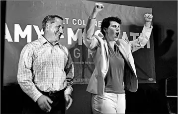  ?? JAMES CRISP/AP ?? Amy McGrath and her husband, Erik Henderson, celebrate her primary win in Kentucky. She backs expansion of the ACA.