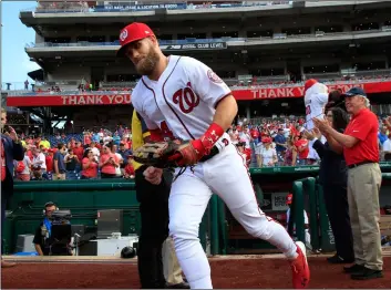 ??  ?? Washington Nationals right fielder Bryce Harper (34), runs to the field from the dugout at the start of the Nationals last home game of the season during baseball game against the Miami Marlins in Washington, on Wednesday.AP PhoTo/MAnuel BAlce ceneTA