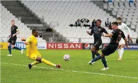  ?? Photograph: Matt McNulty/Manchester City/Getty Images ?? Ferran Torres shoots past Steve Mandanda to score for Manchester City against Marseille.