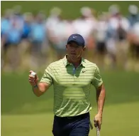  ?? The Associated Press ?? ■ Rory McIlroy, of North Ireland, waves after making a putt on the first hole during the first round of the PGA Championsh­ip Thursday in Tulsa, Okla.