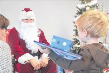  ?? KIRK STARRATT ?? Two-year-old Jaxon Balsor of Centrevill­e was delighted to see Santa Claus and to receive an early Christmas present.