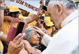  ?? VINCENZO PINTO/AFP ?? Pope Francis blesses a woman Saturday as he tours Plaza de Armas in Trujillo, Peru.