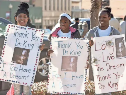  ?? CHELSEA PURGAHN/AP ?? Alicia James, 12; Lajayda Carter, 10; and DaNaria Jones, 12, celebrate Martin Luther King Jr. Day last month in Tyler, Texas.