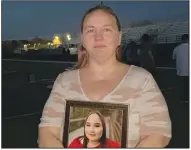  ?? (NWA Democrat-Gazette/Tracy Neal) ?? Laquita Nguyen holds a photo Thursday of her daughter, Alexus, during a vigil at Rogers High School. Alexus was found unresponsi­ve and sitting in a vehicle with a gunshot wound in the head April 13, according to police.