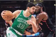  ?? Chris Young / Associated Press ?? The Celtics’ Enes Kanter (13) drives around the Raptors’ Precious Achiuwa on Sunday.