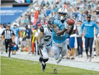  ?? THE ASSOCIATED PRESS ?? Tennessee Titans wide receiver Taywan Taylor dives for a 42-yard catch in front of Jacksonvil­le Jaguars cornerback A.J. Bouye during the second half of this past Sunday’s game in Florida. The Titans pulled away in the final two quarters for a 37-16...