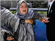  ?? MASSOUD HOSSAINI / AP ?? A woman shouts and cries Sunday at a hospital in Kabul, Afghanista­n, after losing her son in a suicide bombing. The Islamic State has claimed credit for the attack, which came at a government office where people were lined up for national identity cards.