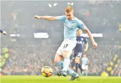  ??  ?? Manchester City’s Belgian midfielder Kevin De Bruyne shoots and scores during the English Premier League football match between Manchester City and Tottenham Hotspur at the Etihad Stadium in Manchester, north west England, on December 16, 2017. - AFP...