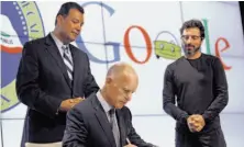  ?? Sarah Rice / Special to The Chronicle ?? Sen. Alex Padilla (left) and Google co-founder Sergey Brin watch as Gov. Jerry Brown signs the law in Mountain View.