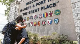  ?? William Luther / Staff photograph­er ?? Gloria Guillén, seated, is comforted by daughter Lupe after talking outside Fort Hood about her missing daughter, Vanessa. Gloria says she pleaded with the Army to find Vanessa.