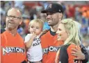  ?? ROB CARR/GETTY IMAGES ?? The Diamondbac­ks’ Robbie Ray poses with his family during All-Star week at Marlins Park in Miami on July 10.