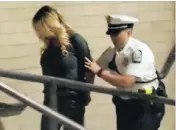  ?? WBNSVIAAP ?? Porn actress Stormy Daniels is led into jail in Columbus, Ohio, on Wednesday after being arrested and accused of letting patrons touch her, a rarely enforced offence.