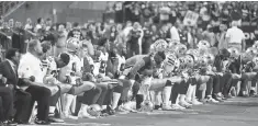  ?? MATT KARTOZIAN, USA TODAY SPORTS ?? Cowboys players, coaches and staff take a knee prior to the national anthem before Monday night’s game vs. the Cardinals.