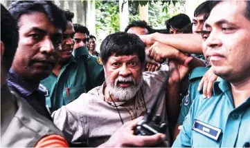  ?? — AFP photo ?? File photo shows Alam arriving for an appearance in court in Dhaka surrounded by policemen.
