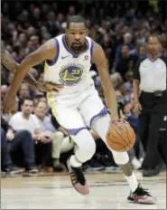  ?? TONY DEJAK — THE ASSOCIATED PRESS ?? Golden State Warriors’ Kevin Durant goes to the basket against the Cleveland Cavaliers during the first half of Game 4 of basketball’s NBA Finals, Friday in Cleveland.
