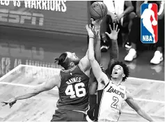  ??  ?? Aron Baynes (left) of the Boston Celtics and Lonzo Ball of the Los Angeles Lakers battle for the ball during the fourth quarter at TD Garden in Boston, Massachuse­tts. — AFP photo