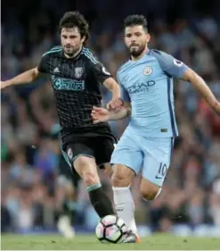  ??  ?? MANCHESTER: West Bromwich Albion’s Claudio Yacob, left, and Manchester City’s Sergio Aguero battle for the ball during the English Premier League soccer match against Manchester City at the Etihad Stadium.— AP
