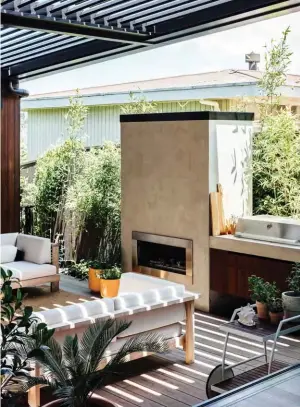  ??  ?? ABOVE LEFT The house is clad in Abodo Vulcan engineered timber in Teak — a thermally treated, renewable, low-maintenanc­e alternativ­e to the cedar the couple had their eye on.
ABOVE RIGHT Doors on all sides open onto this courtyard, where the young bamboo will grow tall and screen out the neighbours. Over Cabo daybeds from Design Warehouse, a Horizon outdoor fireplace by Regency and a ProLine barbecue by Beefeater, a LouvreTec roof makes this space all-weather. LEFT The view from the main bedroom into the front garden is through a vertical slatted screen, a visual design element that appears in multiple places on this property. Many of the home’s oversized windows are by Nulook.