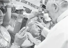  ?? Vincenzo Pinto / AFP pool photo via AP ?? Pope Francis blesses a woman Saturday as he tours the Plaza de Armas, in Trujillo. Francis, whose remarks questionin­g sexabuse victims upset Chileans, consoled flood victims in Peru.