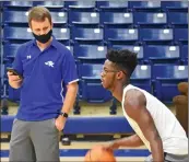  ??  ?? Madison Leach, left, assists Bald Knob junior Marcus McGahee during a practice June 29 at the high school. Leach replaces Matt Ragsdale, who left to be an assistant senior high coach at Nettleton.