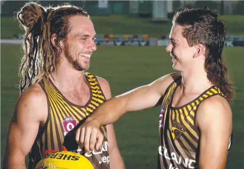  ??  ?? HAIR’S TO US: Manunda Hawks football club players and brothers Ryan and Corey Flint are proud of their locks. Picture: ANNA ROGERS