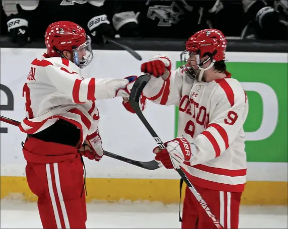  ?? STUART CAHILL — BOSTON HERALD ?? Boston University forward Dylan Peterson (13) celebrates his goal with forward Ryan Greene during Friday’s semifinal win over Providence. The Terriers won the Hockey East title Saturday by defeating Merrimack in overtime.
