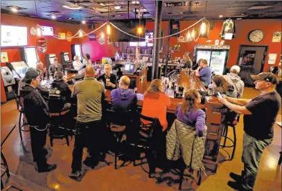  ?? William Glasheen The Associated Press ?? The Dairyland Brew Pub opens to patrons Wednesday in Appleton, Wis., following the Wisconsin Supreme Court’s decision to strike down Gov. Tony Evers’ safer-at-home order amid the coronaviru­s pandemic.