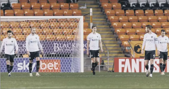  ?? Pictures: Daniel Chesterton/phcimages.com ?? FEELING THE PAIN Sean Raggett, centre, and four of his Pompey team-mates look dejected after conceding what turned out to be the only goal of last night’s League One game away to Blackpool.