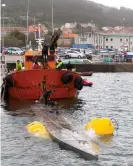  ?? ?? A crane ship tries to refloat the narco-sub off Cangas de Morrazo in Galicia, Spain, in November 2019. Photograph: Salvador Sas/ EPA