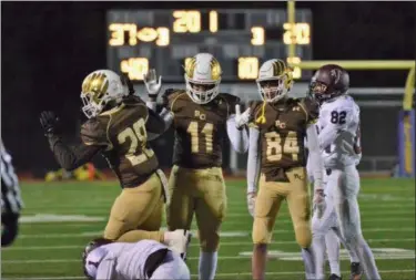  ?? THOMAS NASH - DIGITAL FIRST MEDIA ?? Bethlehem Catholic’s Zaccheus Brake (11) celebrates with teammates after tackling a Pottsgrove ball carrier during the third quarter of Friday night’s PIAA-4A playoff game.