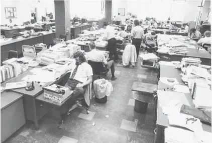  ?? BALTIMORE SUN ?? File photo of Baltimore Sun newsroom in 1974. After 68 years at 501 N. Calvert St., the paper is moving south to Port Covington.