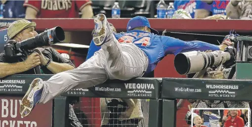  ?? | AP ?? Anthony Rizzo dives into a camera well to catch a pop-up. The runner on third was awarded home because Rizzo landed out of play.